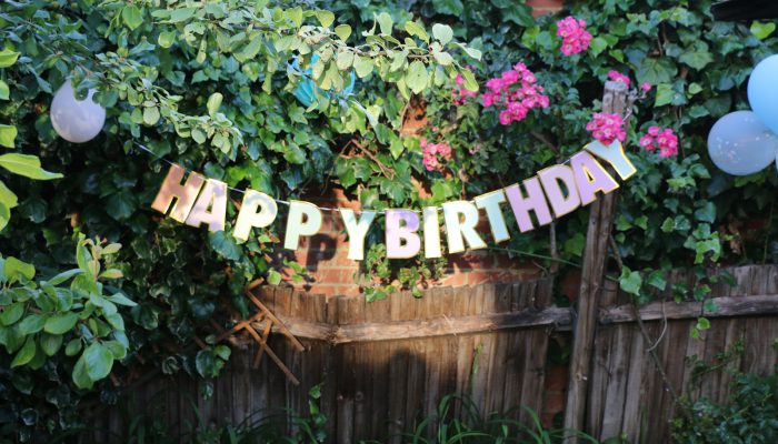 a sign in front of a fence